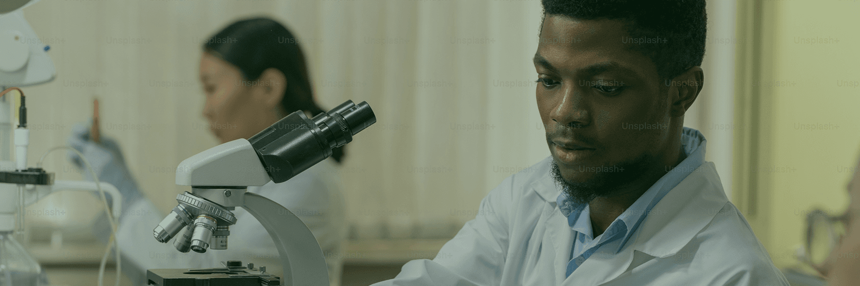 A researcher at a microscope