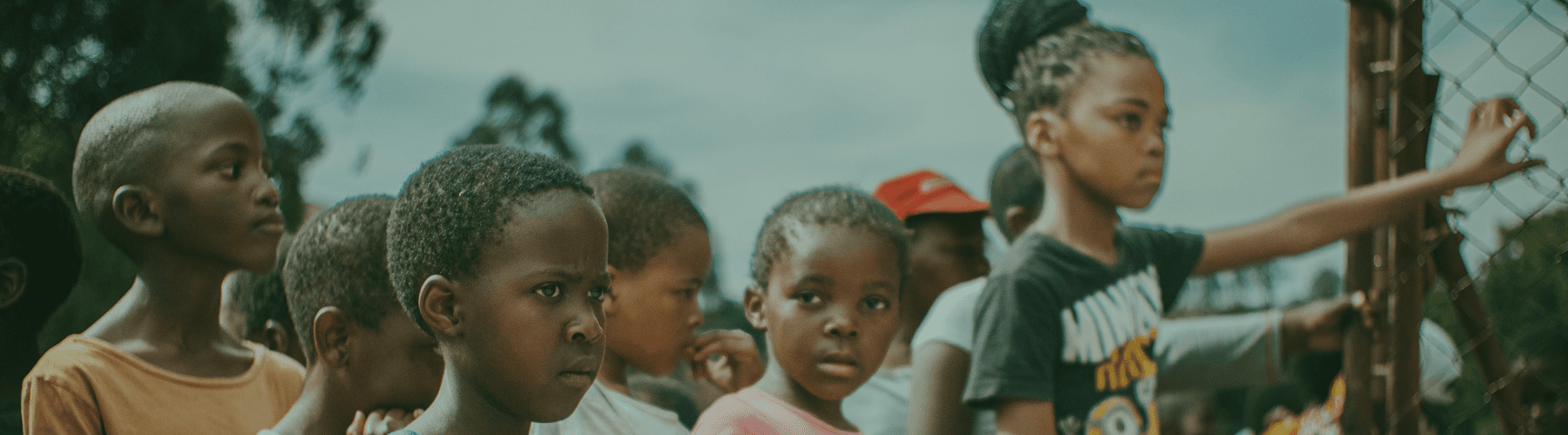 Children gathered at a fence in Salima