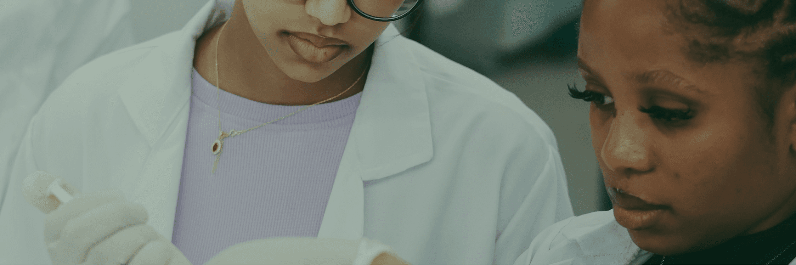 Students in lab coats working in a laboratory